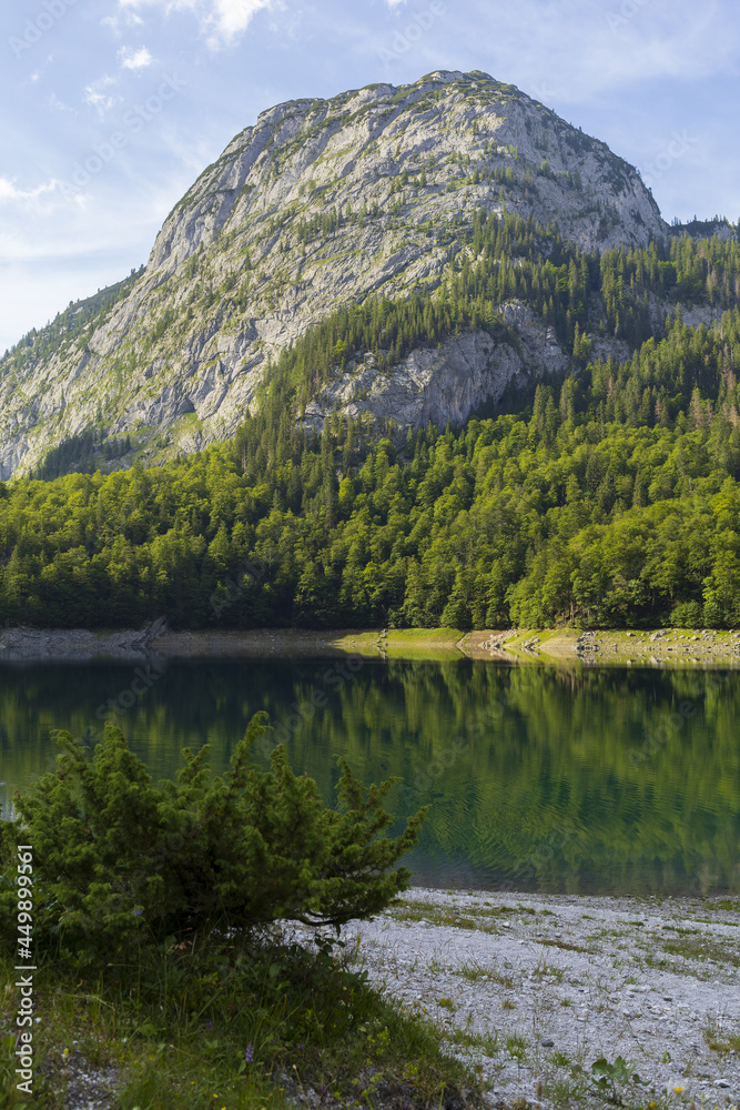 Gosau lake surrounded by Austrian Alps with Hoher Dachstein mountains view and reflections in summer sunny day