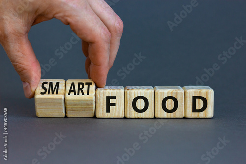 Smart food symbol. Doctor turns cubes and changes words 'food' to 'smart food'. Beautiful grey background. Medical, smart food concept. Copy space.
