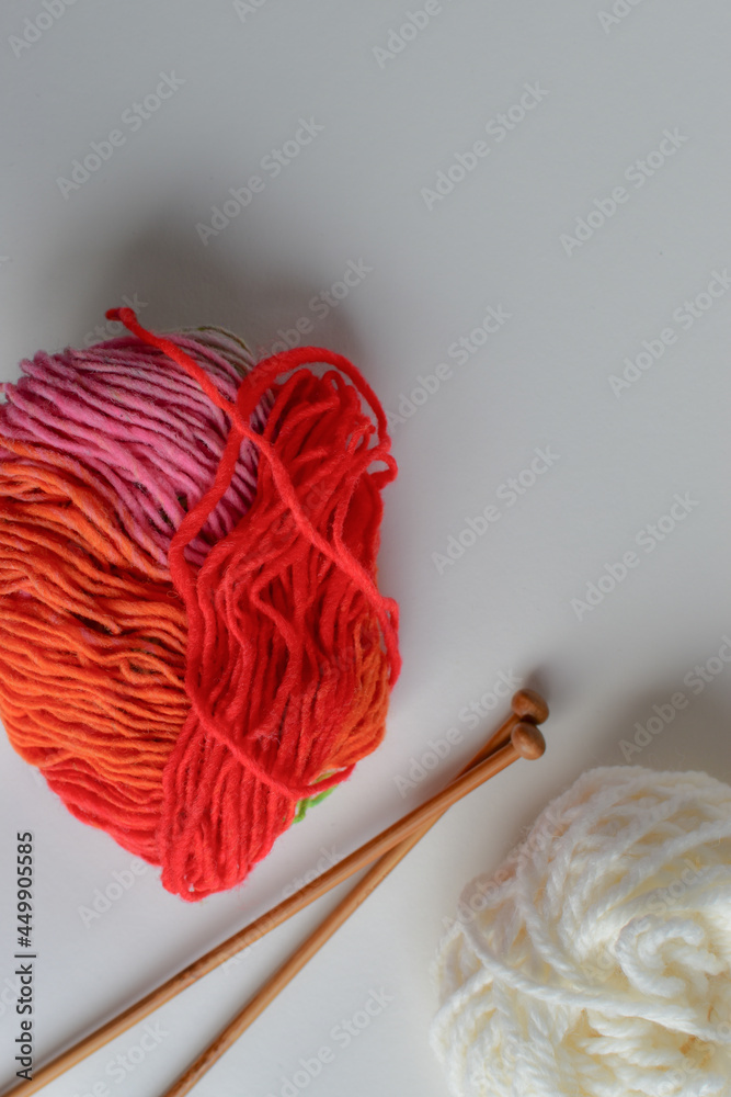 red knitting wool and knitting needles red knitting wool and knitting needles