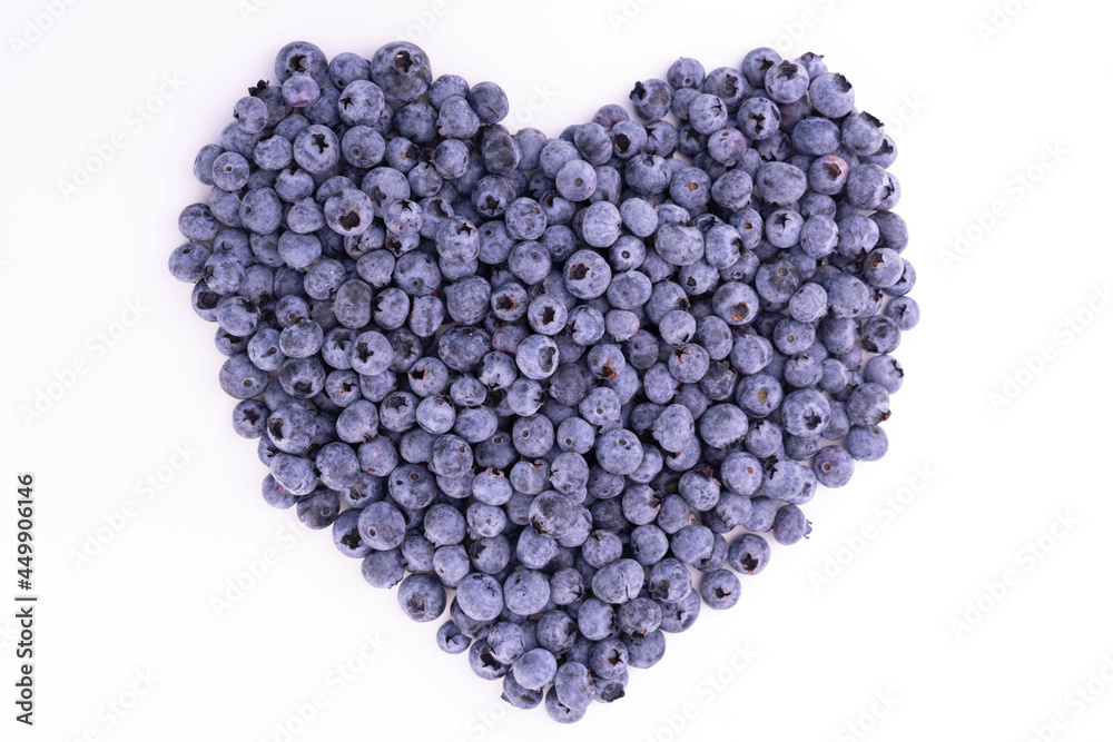 Big heart made from fresh blueberries on a white background.
Big heart made from fresh blueberries on a white background.