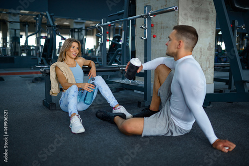 Couple relax after fitness training in gym