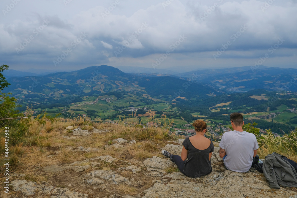 couple sitting in the mountains and watching the aerial view. Hiking, camping, trekking. Couple time together