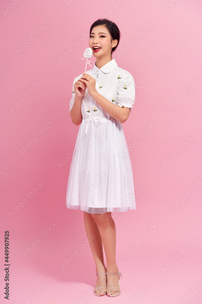 Young pretty woman with candies on colorful background Young pretty woman with candies on colorful background