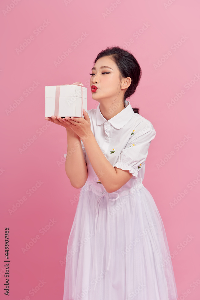 portrait of fascinating girl making kissing face expressing while holding big gift. portrait of fascinating girl making kissing face expressing while holding big gift.