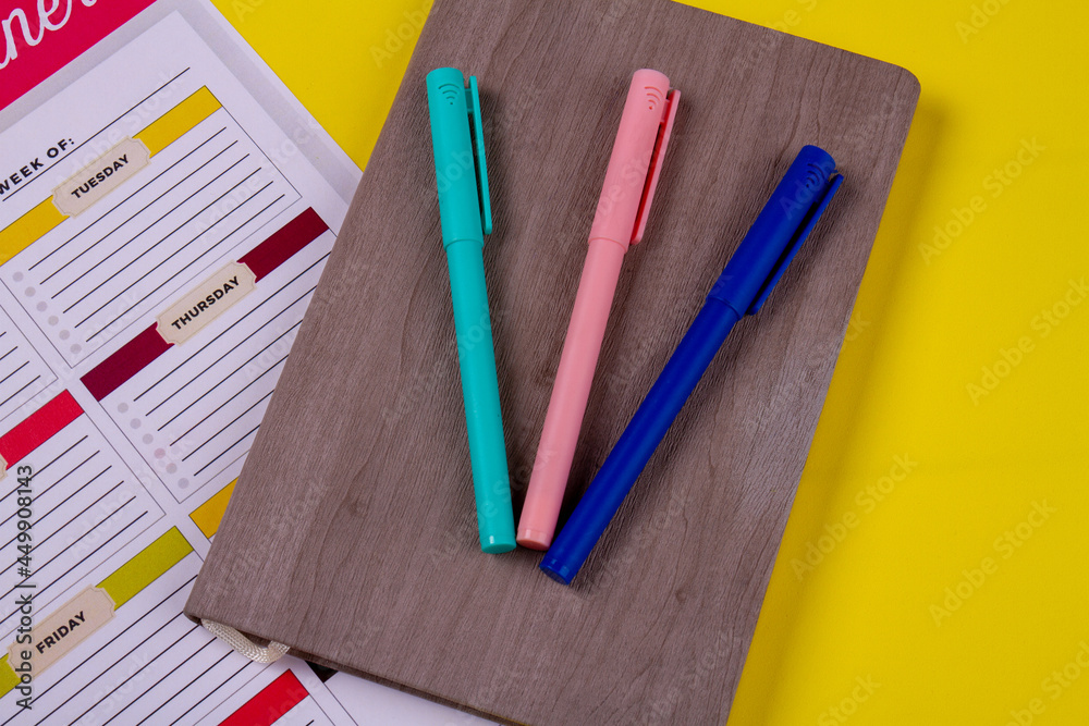 Top view three colored felt-pens on the book. Top view three colored felt-pens on the book.