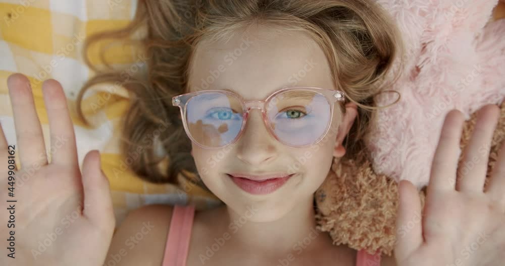 Portrait teenage Girl Looking at Camera say hello with blond hair and glasses 