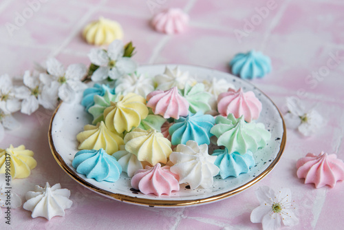 Small colorful meringues in the ceramic plate