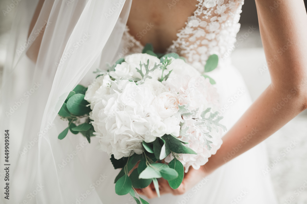 Bride holding big and beautiful wedding bouquet with flowers Bride holding big and beautiful wedding bouquet with flowers