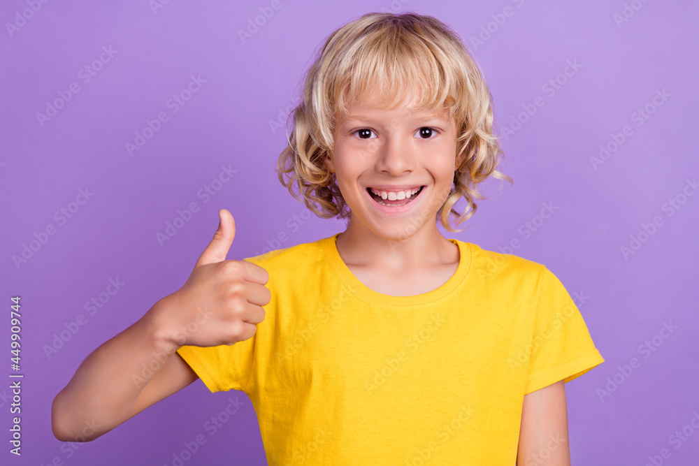 Photo of young cheerful positive happy boy smile make thumb up smile isolated on purple color background Photo of young cheerful positive happy boy smile make thumb up smile isolated on purple color background