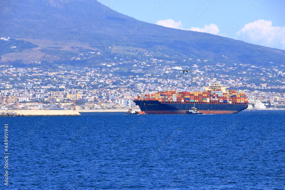 July 11 2021 Napoli in Italy in Europe: A picture of the city of Naples with a cargo ship in the gulf.
