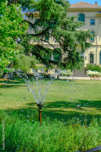 Parma, Italy: Fondation Magnani Rocca. Beautiful building of museum across garden and fountain with bubbling water photo