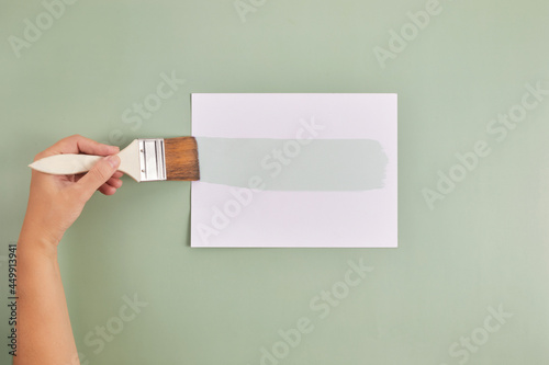 Happy Left Hander's Day. Left hand hold brush and writing text. photo