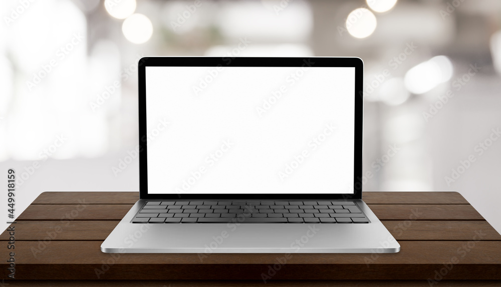 Laptop with blank screen on table with blurred restaurant background Laptop with blank screen on table with blurred restaurant background