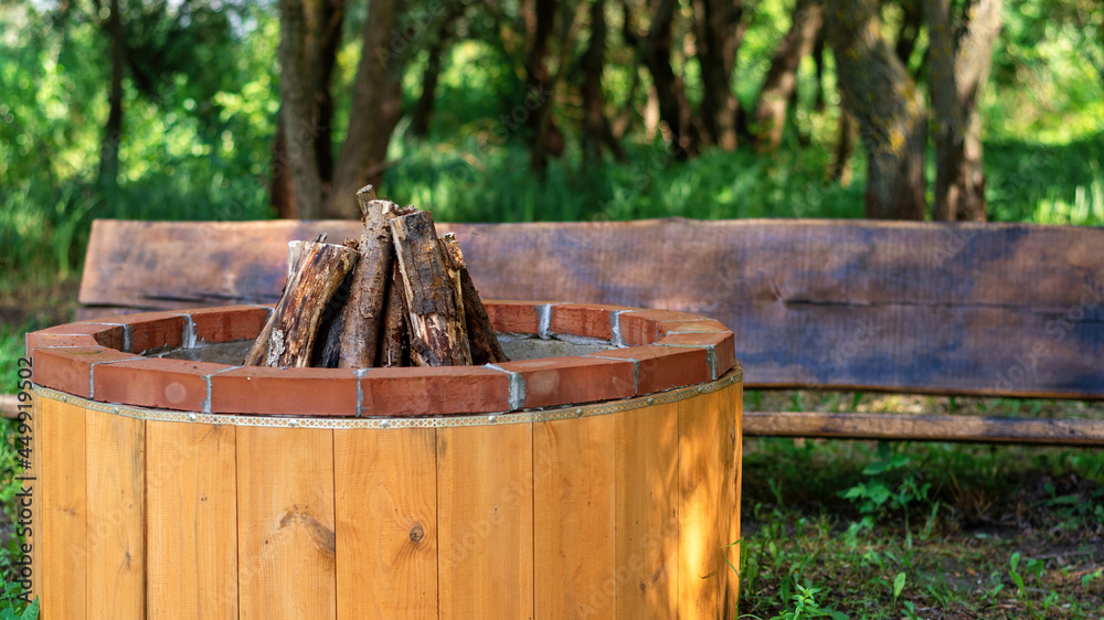 Fototapeta premium Place for campfire with wooden bench at glamping