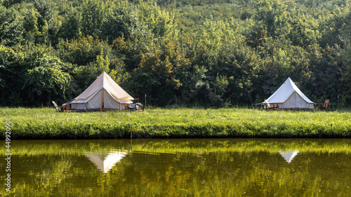Glamping, few tents, lake on the foreground © frimufilms