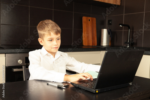 Cheerful child close up during online lesson. photo