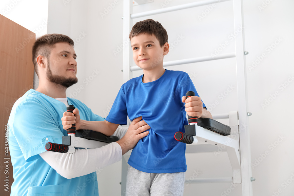 Fototapeta premium Physiotherapist working with boy in rehabilitation center