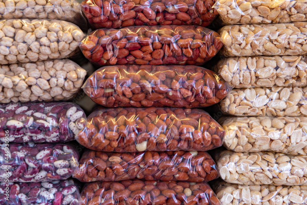 Natural peeled peanuts, hazelnuts, beans, packed in plastic bags and sold in the store. The nuts are already on the shelf and ready for sale in the market. Diet, healthy eating. Healthy food. Natural peeled peanuts, hazelnuts, beans, packed in plastic bags and sold in the store. The nuts are already on the shelf and ready for sale in the market. Diet, healthy eating. Healthy food.