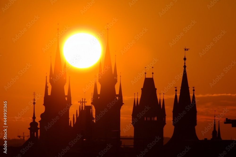 Sun rising behind the towers of Church of Our Lady before Týn