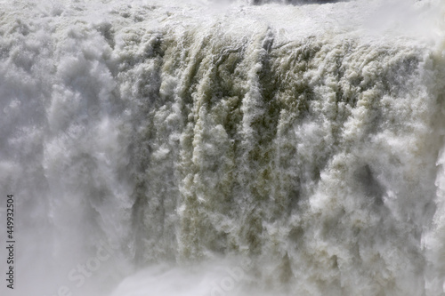 Natural background. Power in water. Closeup view of the famous Iguazu falls in Misiones, Argentina. The mist and falling white water beautiful texture, motion and pattern.