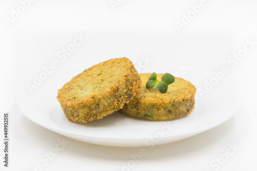 Vegetarian vegetable cutlets on a plate on a white background.