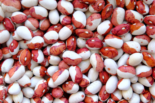 Red and white beans as a background to describe the preparation of legumes. View from above. Large