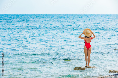 young pretty woman in straw hat at sea beach