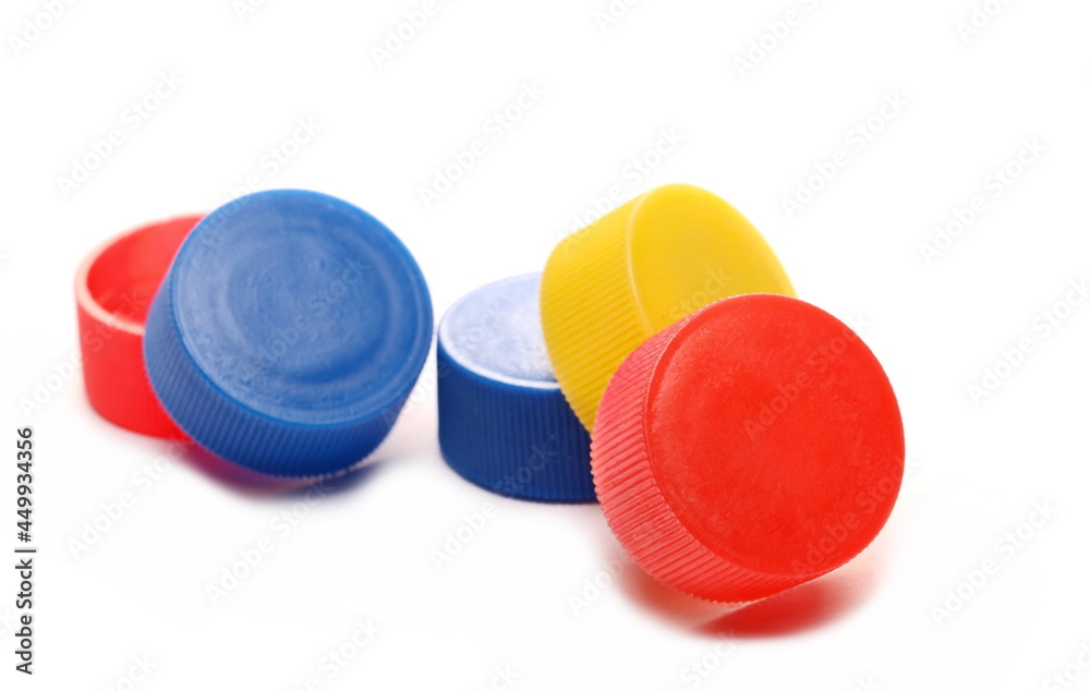 Colorful plastic bottle caps pile isolated on white background Colorful plastic bottle caps pile isolated on white background