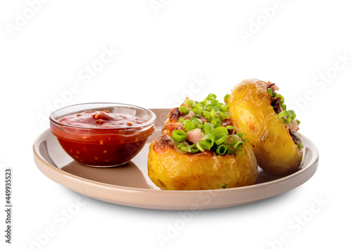 Plate with baked potato and sauce on white background