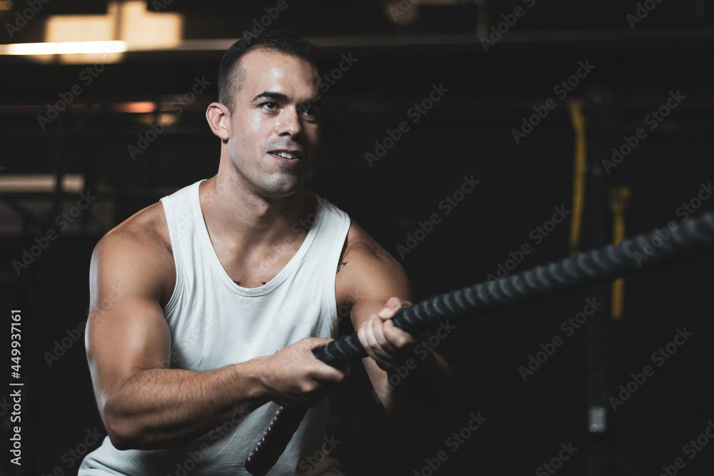 a Turkish boy pulling a rope inside a gym. a Turkish boy pulling a rope inside a gym.