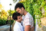 Boy kissing his boyfriend in the street. Gay couple in love.