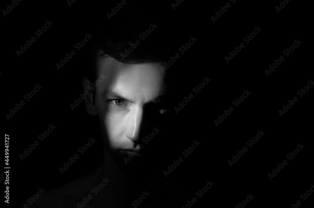 dramatic portrait of a man on black background