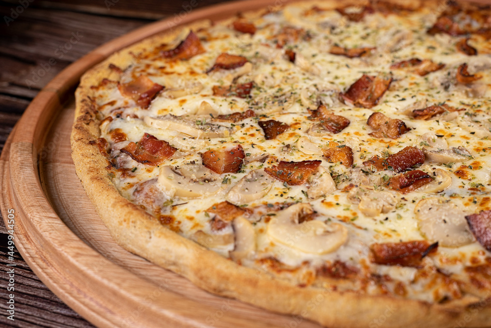 Pizza with mushrooms, cheese and bacon