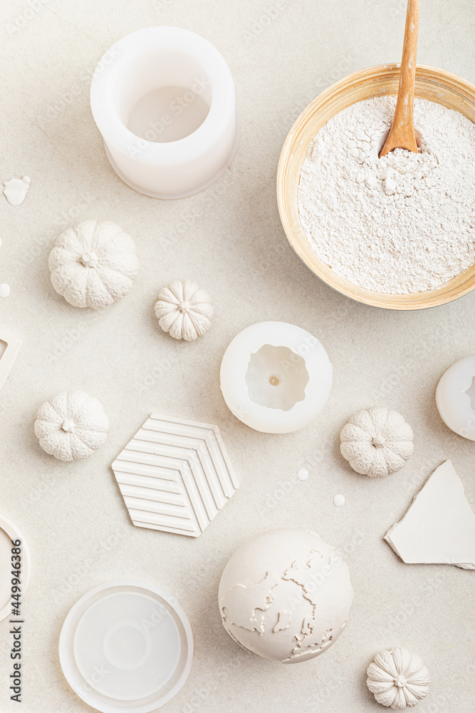 Handmade craft molds, plaster powder and gypsum objects for interior decoration. Artisan, small business, diy, hobby concept. Top view Handmade craft molds, plaster powder and gypsum objects for interior decoration. Artisan, small business, diy, hobby concept. Top view