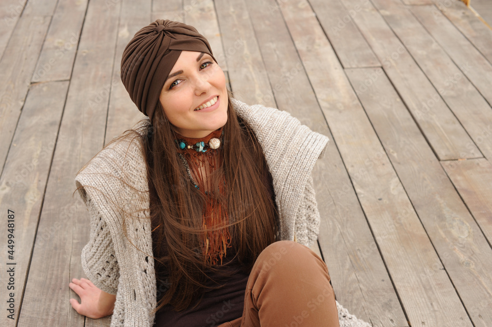 Happy smiling brunette woman portrait dressed in jersey turban, autumn fashion concept