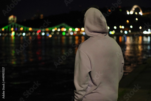 person looks at the street landscape at night