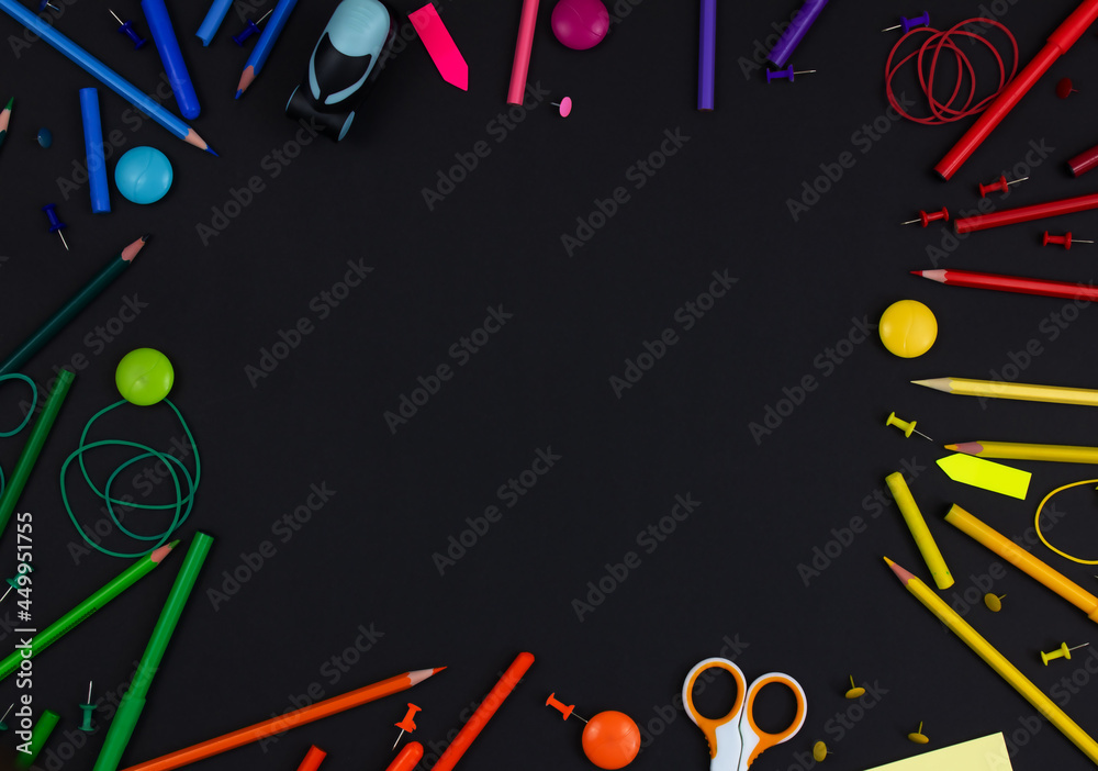 Multicolored stationery on a black background. Copy space. Back to school concept