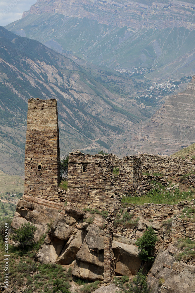 ancient stone battle tower in abandoned village old Kahib in Dagestan with scenery mountain valley background