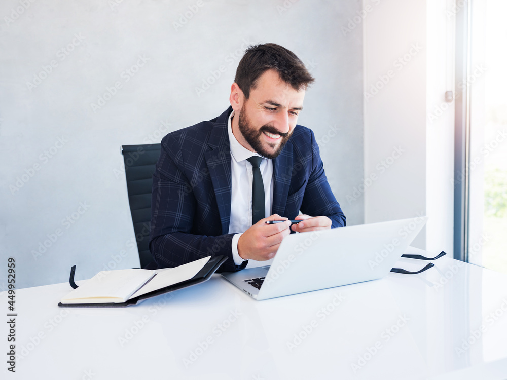 Cheerful young entrepreneur talking in online meeting, using pen and notebook to write down new ideas. Cheerful young entrepreneur talking in online meeting, using pen and notebook to write down new ideas.