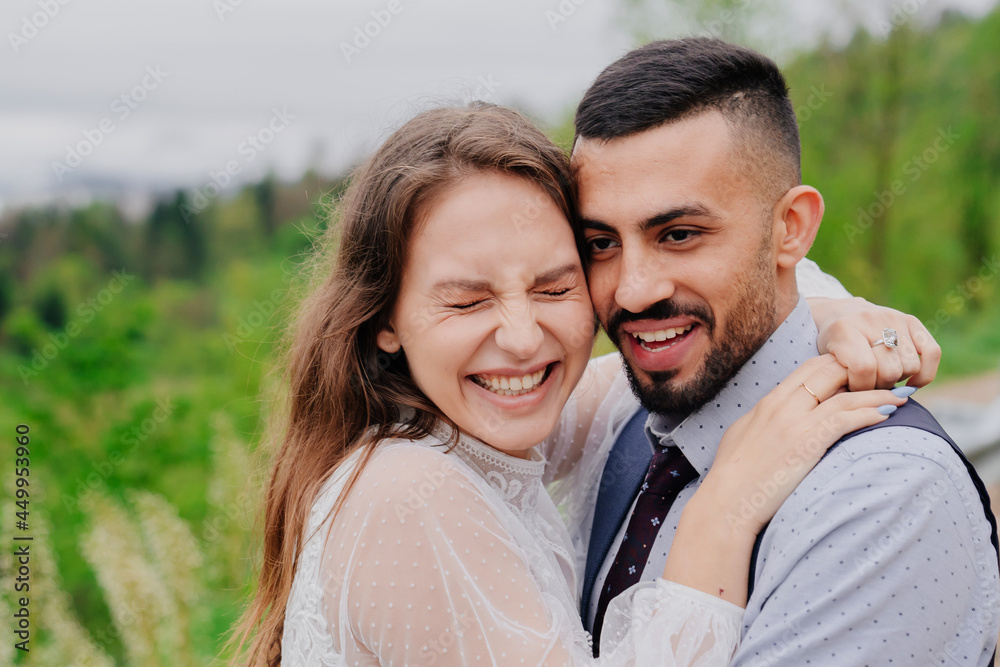 the bride and groom cuddling and laugh in nature. romance in the relationship the bride and groom cuddling and laugh in nature. romance in the relationship