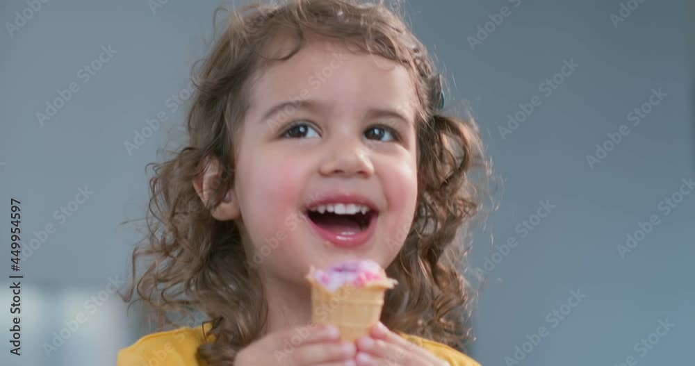 Cute toddler girl eating ice cream cone. Cute toddler girl eating ice cream cone.