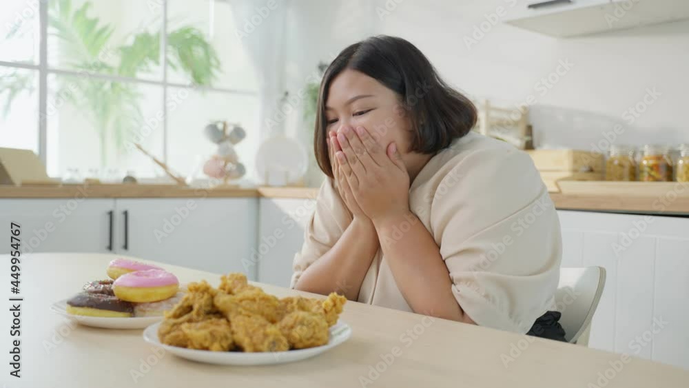 Asian young oversize big women feel happy for unhealthy foods on plate Asian young oversize big women feel happy for unhealthy foods on plate