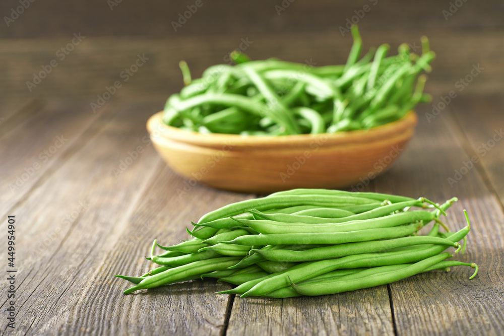 fresh green beans on a wooden table, selective focus. fresh green beans on a wooden table, selective focus.