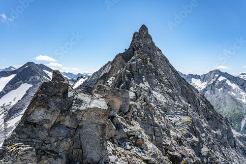 Pointed rocky mountain ridge on sunny summer day. Schwarzkopf peak in Zillertaler Alps, Austria