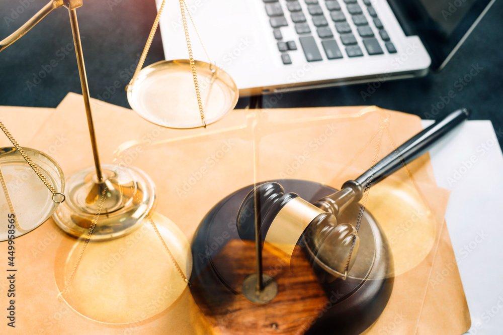 Business and lawyers discussing contract papers with brass scale on desk in office. Law, legal services, advice, justice and law concept picture with film grain effect Business and lawyers discussing contract papers with brass scale on desk in office. Law, legal services, advice, justice and law concept picture with film grain effect
