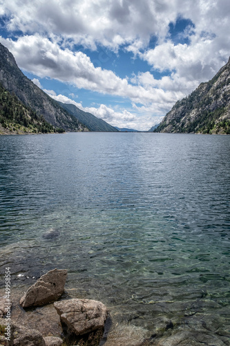 Cavallers reservoir surrounded by high mountains , river Noguera de Tor in Ribagorza, Boi valley, in the Lleida Pyrenees, Catalonia, Spain, vertical