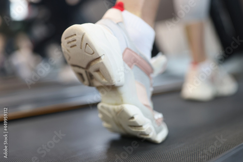 Sneaker shoe of sport girl exercise running on treadmill machine