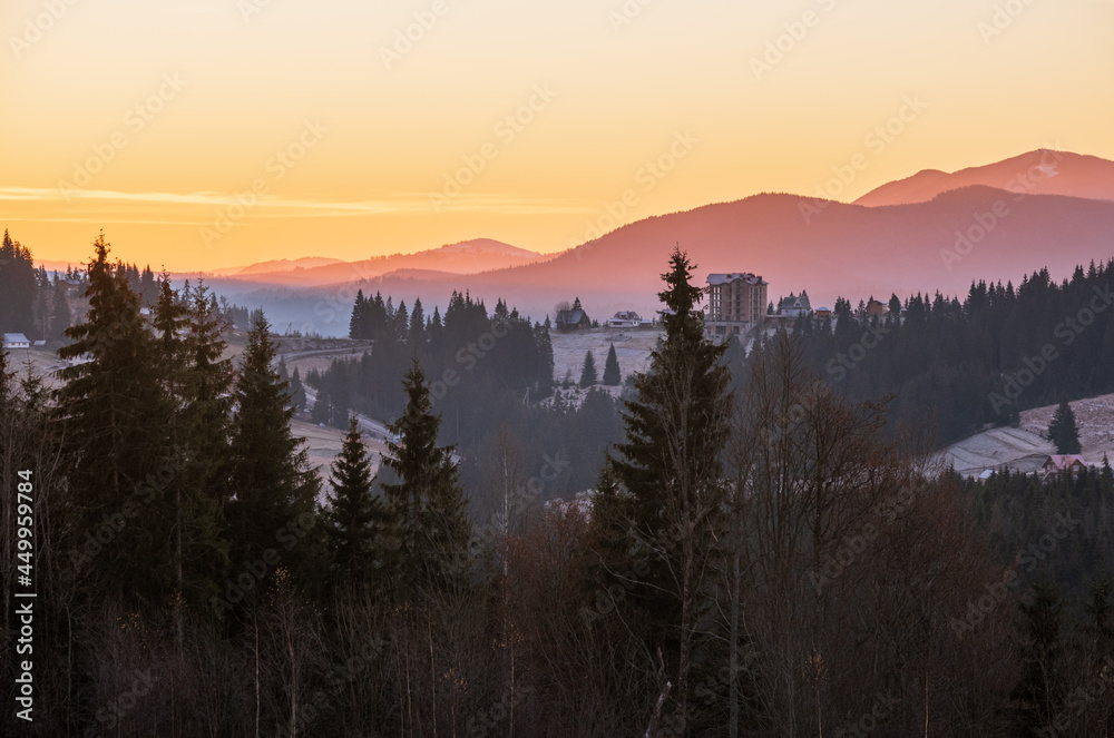 Picturesque sunrise above late autumn mountain countryside.  Ukraine, Carpathian Mountains. Peaceful traveling, seasonal, nature and countryside beauty concept scene.