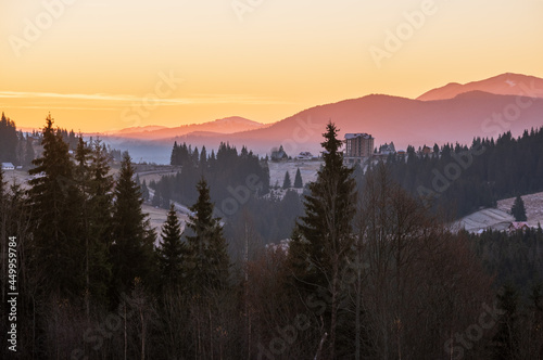 Picturesque sunrise above late autumn mountain countryside.  Ukraine, Carpathian Mountains. Peaceful traveling, seasonal, nature and countryside beauty concept scene.