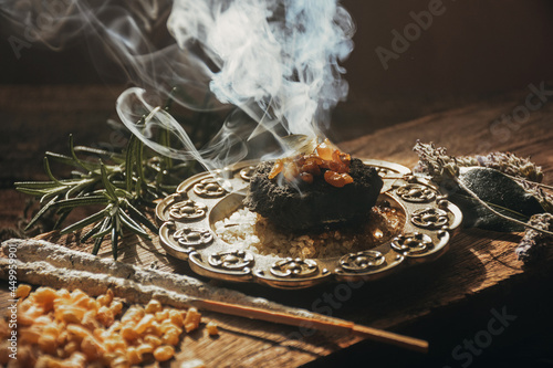Charcoal burning with incense, incense resin, rosemary, laurel, lavender on a rustic wooden table, 
smudge stick, smudging, energetic cleansing and smoking.Sahumar
 photo